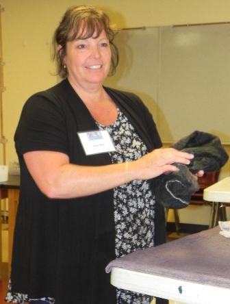 A happy student learning to wet felt